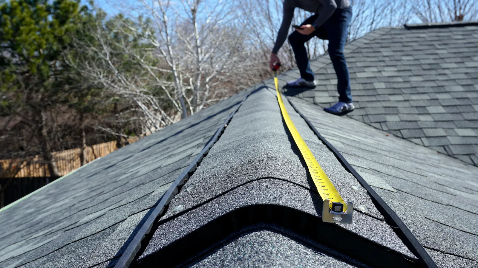 Tape measure used by a roofer to measure along a shingle ridge
